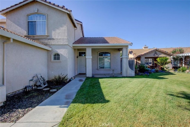 1166 Labrador Ct, Newman, CA 95360 - view of front facade with a tiled roof, a front yard, stucco siding, and covered porch