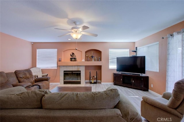 1166 Labrador Ct, Newman, CA 95360 - living room featuring wood finished floors, a ceiling fan, and a fireplace