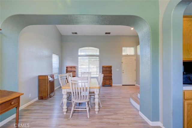 1166 Labrador Ct, Newman, CA 95360 - dining space with arched walkways and light wood-style flooring
