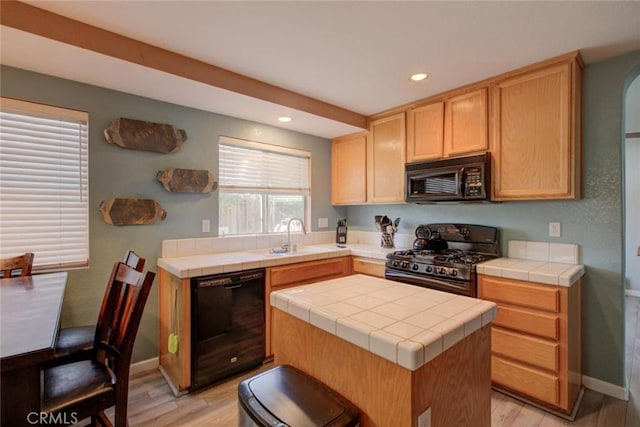 1166 Labrador Ct, Newman, CA 95360 - kitchen with tile counters, light wood-style floors, black appliances, recessed lighting, and light brown cabinetry