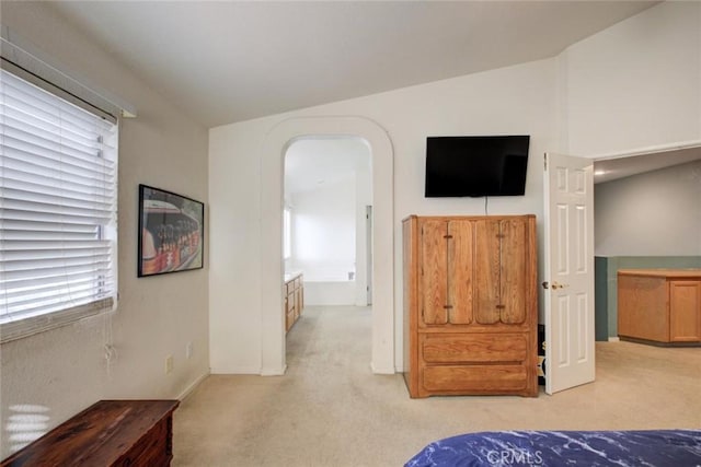 1166 Labrador Ct, Newman, CA 95360 - bedroom featuring light carpet, multiple windows, lofted ceiling, and arched walkways