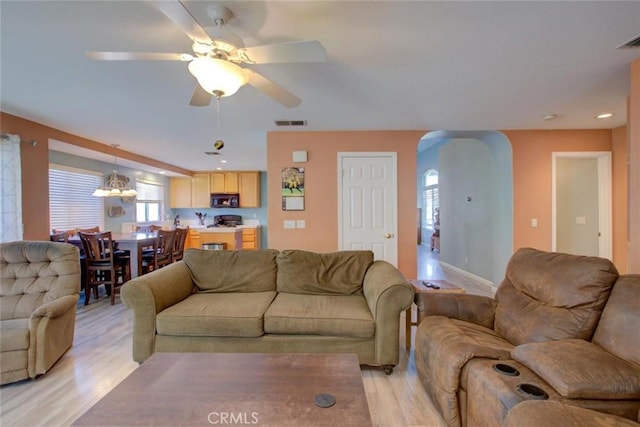 1166 Labrador Ct, Newman, CA 95360 - living room featuring arched walkways, light wood-style flooring, ceiling fan, and recessed lighting