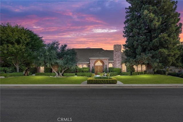 8905 Saint Cloud Ln, Bakersfield, CA 93311 - view of front facade featuring a yard and a chimney