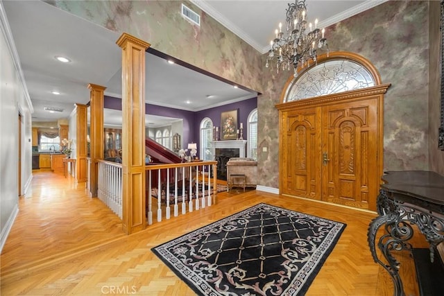 8905 Saint Cloud Ln, Bakersfield, CA 93311 - foyer with wallpapered walls, ornate columns, a fireplace, crown molding, and a chandelier