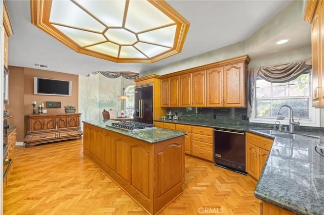 8905 Saint Cloud Ln, Bakersfield, CA 93311 - kitchen with a center island, black dishwasher, built in fridge, brown cabinets, and backsplash