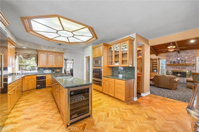 8905 Saint Cloud Ln, Bakersfield, CA 93311 - kitchen featuring a ceiling fan, wine cooler, open floor plan, glass insert cabinets, and tasteful backsplash