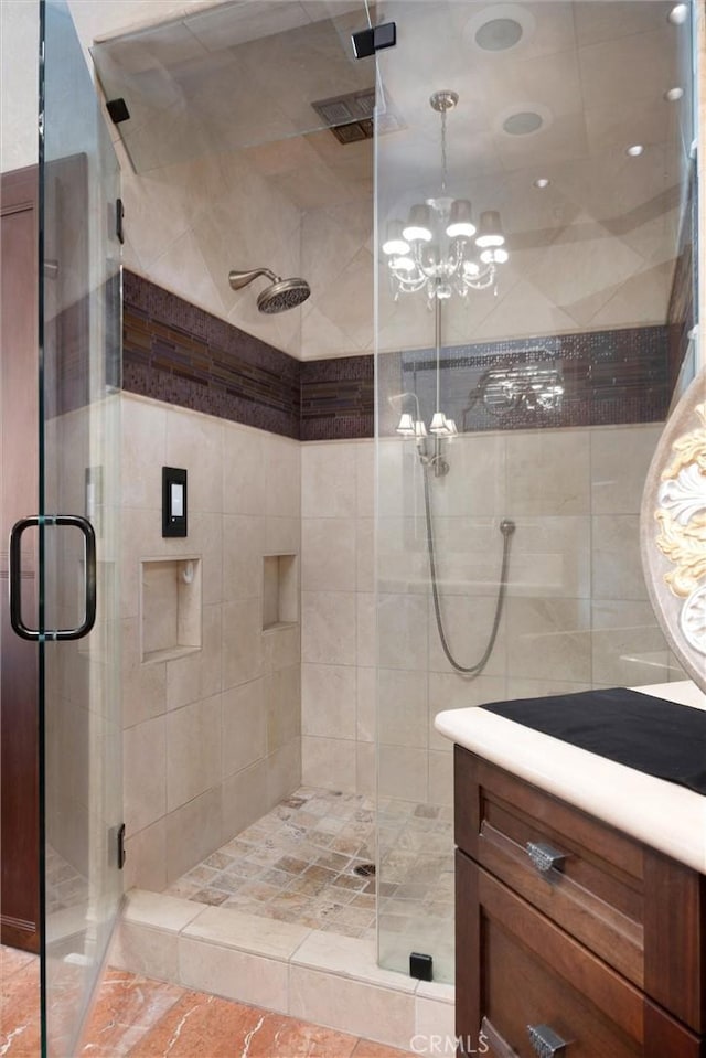 8905 Saint Cloud Ln, Bakersfield, CA 93311 - bathroom featuring a shower stall, a chandelier, and vanity