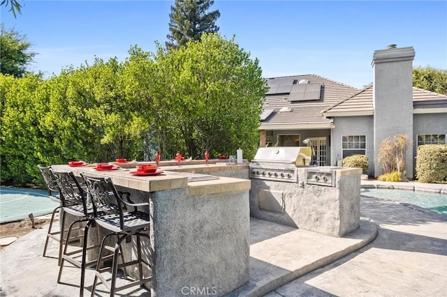 8905 Saint Cloud Ln, Bakersfield, CA 93311 - view of patio with exterior kitchen and an outdoor pool