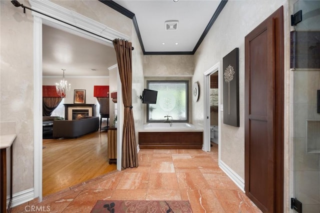8905 Saint Cloud Ln, Bakersfield, CA 93311 - hallway with ornamental molding, plenty of natural light, and a chandelier