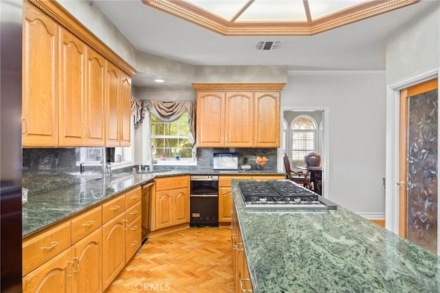8905 Saint Cloud Ln, Bakersfield, CA 93311 - kitchen with healthy amount of natural light, dark stone counters, stainless steel gas cooktop, decorative backsplash, and crown molding