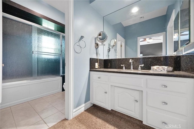 8905 Saint Cloud Ln, Bakersfield, CA 93311 - bathroom with a ceiling fan, bath / shower combo with glass door, vanity, tile patterned flooring, and backsplash