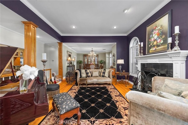 8905 Saint Cloud Ln, Bakersfield, CA 93311 - living area with decorative columns, wood finished floors, a chandelier, crown molding, and a tile fireplace