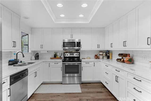 1330 W Apricot Ave, Lompoc, CA 93436 - kitchen with stainless steel appliances, crown molding, a tray ceiling, recessed lighting, and white cabinetry