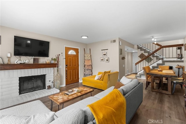 1330 W Apricot Ave, Lompoc, CA 93436 - living room featuring wood finished floors, stairway, and a brick fireplace