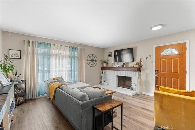1330 W Apricot Ave, Lompoc, CA 93436 - living area with healthy amount of natural light, a fireplace, and wood finished floors
