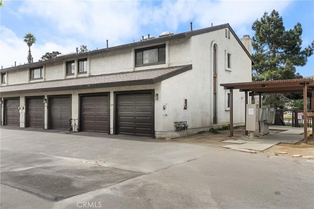 1330 W Apricot Ave, Lompoc, CA 93436 - view of front of house featuring a chimney, stucco siding, a pergola, and roof with shingles