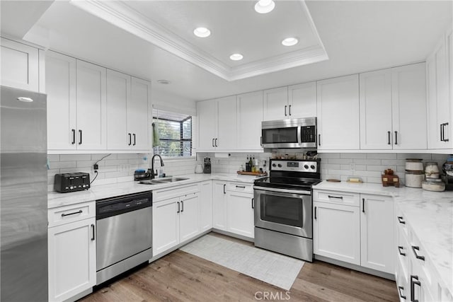 1330 W Apricot Ave, Lompoc, CA 93436 - kitchen featuring a raised ceiling, appliances with stainless steel finishes, white cabinets, recessed lighting, and crown molding
