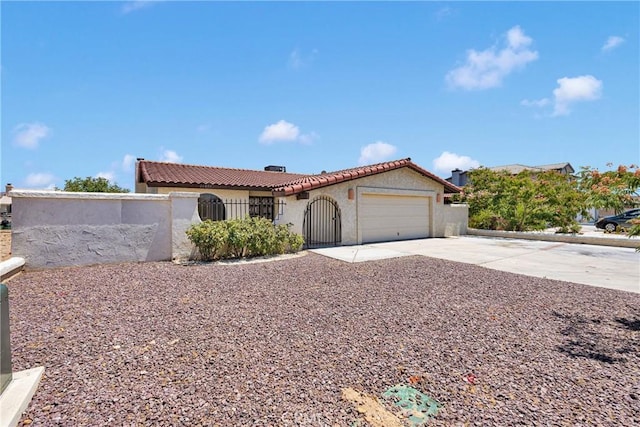 26453 Buccaneer Ln, Helendale, CA 92342 - mediterranean / spanish-style home featuring a tiled roof, driveway, a garage, and stucco siding