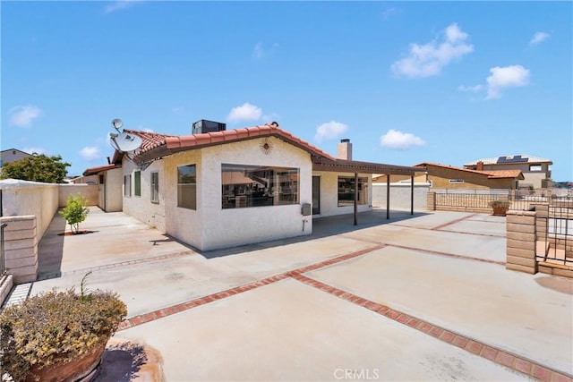 26453 Buccaneer Ln, Helendale, CA 92342 - rear view of house with a chimney, a fenced backyard, stucco siding, and a patio area