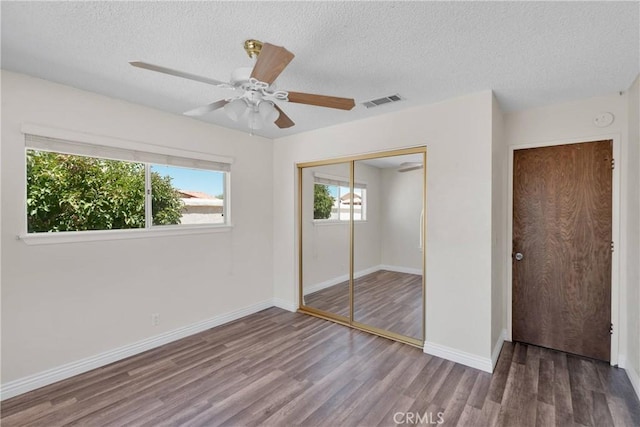 26453 Buccaneer Ln, Helendale, CA 92342 - unfurnished bedroom with a textured ceiling, wood finished floors, a closet, and a ceiling fan
