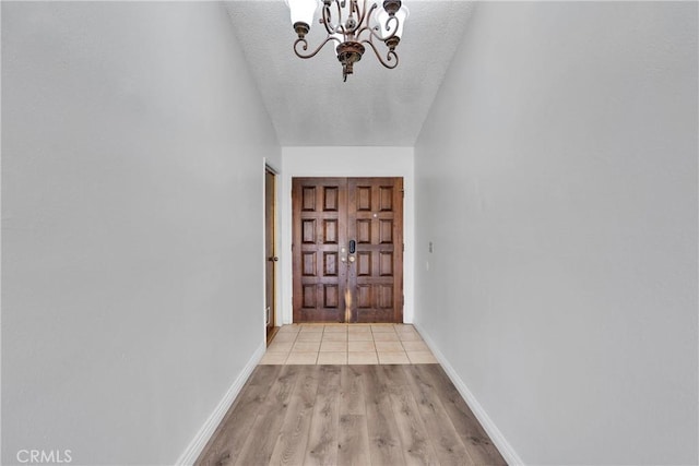 26453 Buccaneer Ln, Helendale, CA 92342 - doorway with a chandelier, a textured ceiling, and light wood-type flooring