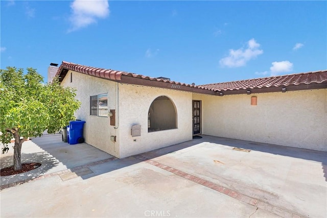 26453 Buccaneer Ln, Helendale, CA 92342 - rear view of house featuring stucco siding and a patio