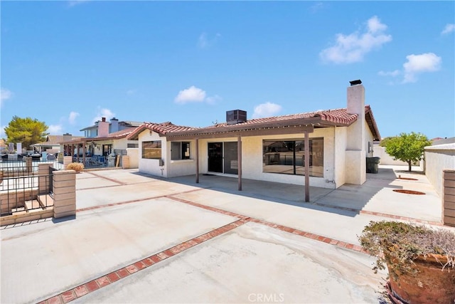 26453 Buccaneer Ln, Helendale, CA 92342 - rear view of house featuring a chimney, stucco siding, a patio, and a tile roof