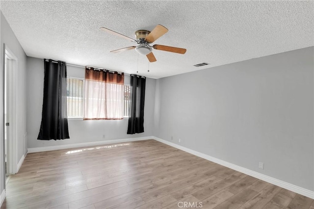 26453 Buccaneer Ln, Helendale, CA 92342 - unfurnished room featuring a ceiling fan, light wood-style floors, and a textured ceiling