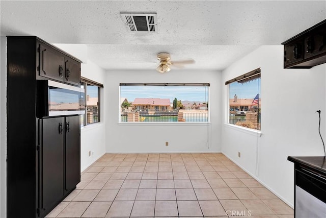 26453 Buccaneer Ln, Helendale, CA 92342 - kitchen with a ceiling fan, a textured ceiling, light tile patterned floors, and stainless steel microwave