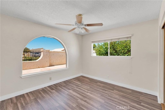 26453 Buccaneer Ln, Helendale, CA 92342 - empty room featuring wood finished floors, a ceiling fan, and a textured ceiling