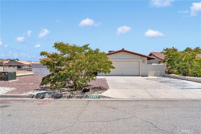 26453 Buccaneer Ln, Helendale, CA 92342 - view of front facade with a garage, stucco siding, concrete driveway, and a tile roof