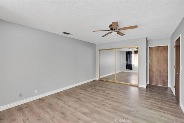 26453 Buccaneer Ln, Helendale, CA 92342 - unfurnished bedroom with a textured ceiling, wood finished floors, and ceiling fan