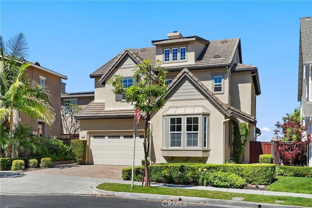 7 Sachem Way, Ladera Ranch, CA 92694 - view of front of home with a garage, driveway, stucco siding, and a tiled roof