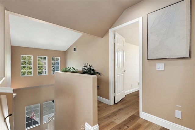 7 Sachem Way, Ladera Ranch, CA 92694 - hall with wood finished floors, vaulted ceiling, and an upstairs landing
