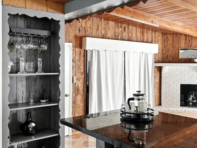 20319 Vanowen St, Winnetka, CA 91306 - kitchen featuring wooden walls, a fireplace, and a wood ceiling with exposed beams