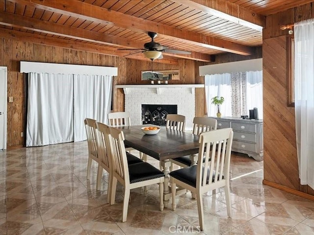 20319 Vanowen St, Winnetka, CA 91306 - dining area featuring wood walls, a wooden ceiling with exposed beams, ceiling fan, and a brick fireplace
