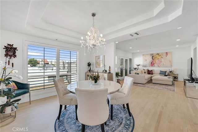 5224 Zelzah Ave Unit 208, Encino, CA 91316 - dining space with a raised ceiling, a chandelier, light wood-style floors, and recessed lighting