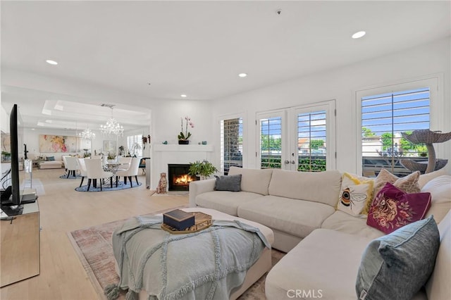 5224 Zelzah Ave Unit 208, Encino, CA 91316 - living area with recessed lighting, wood finished floors, a chandelier, and a fireplace with flush hearth