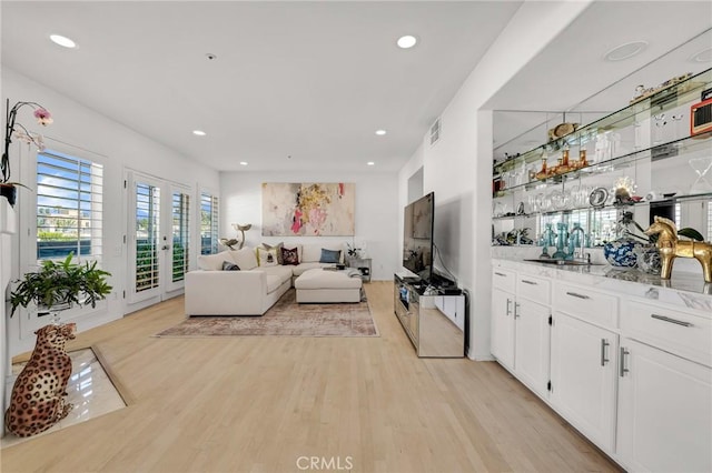 5224 Zelzah Ave Unit 208, Encino, CA 91316 - living area featuring light wood-style flooring, recessed lighting, and bar area