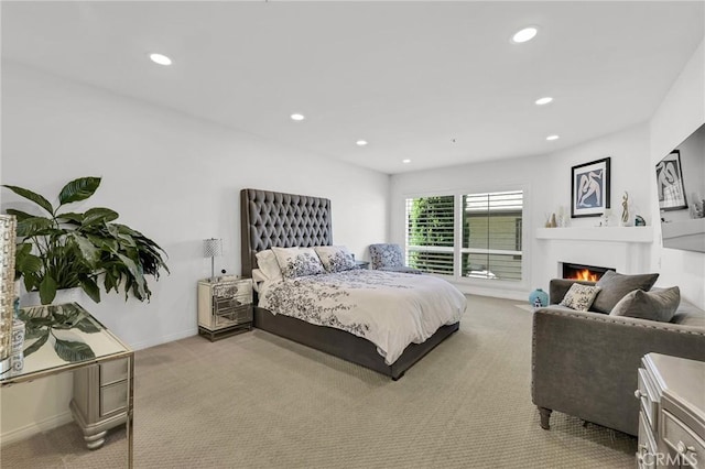 5224 Zelzah Ave Unit 208, Encino, CA 91316 - bedroom featuring light carpet, recessed lighting, and a lit fireplace