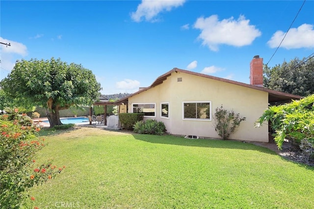 2912 Fragancia Ave, Hacienda Heights, CA 91745 - back of property with stucco siding, a yard, a chimney, and an outdoor pool