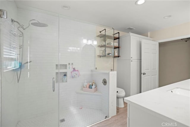 33 Miner St, Bakersfield, CA 93305 - bathroom with vanity, a stall shower, wood finished floors, and recessed lighting