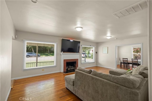 33 Miner St, Bakersfield, CA 93305 - living room featuring wood finished floors and a fireplace