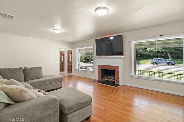 33 Miner St, Bakersfield, CA 93305 - living room with wood finished floors and a brick fireplace