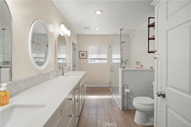 33 Miner St, Bakersfield, CA 93305 - bathroom featuring a stall shower, double vanity, wood finished floors, and recessed lighting