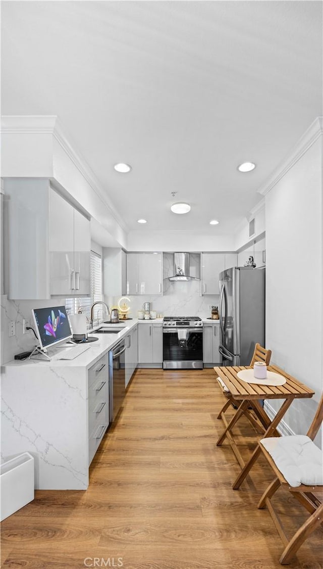 565 E San Jose Ave Unit 204, Burbank, CA 91501 - kitchen featuring gray cabinetry, appliances with stainless steel finishes, light wood-style floors, backsplash, and crown molding