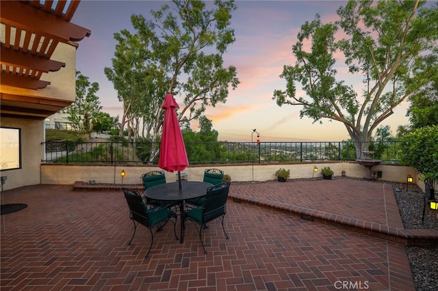 1610 Via Estrella, Pomona, CA 91768 - patio terrace at dusk with a patio area, outdoor dining area, and a fenced backyard