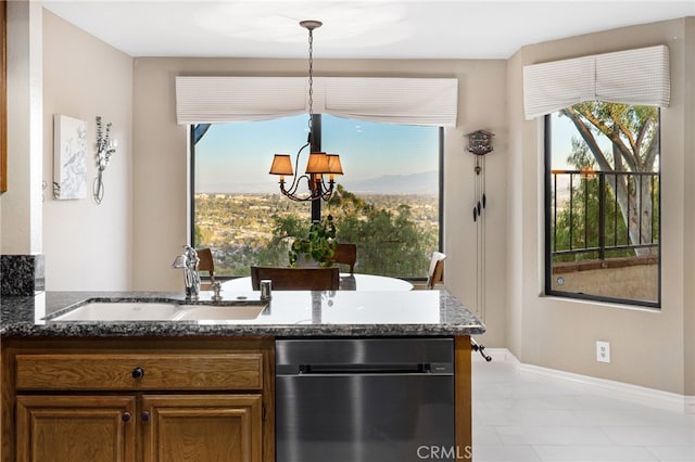 1610 Via Estrella, Pomona, CA 91768 - kitchen featuring stainless steel dishwasher, dark stone counters, a chandelier, and brown cabinetry