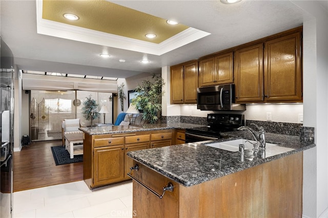 1610 Via Estrella, Pomona, CA 91768 - kitchen featuring a peninsula, a raised ceiling, ornamental molding, brown cabinetry, and electric range