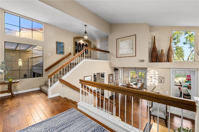 1610 Via Estrella, Pomona, CA 91768 - staircase with healthy amount of natural light, wood-type flooring, a high ceiling, and arched walkways